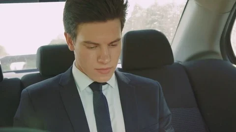 Handsome young businessman going in the car and working with tablet 4K Stock Footage
