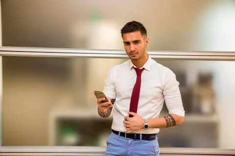 Handsome young businessman using cell phone Stock Photos