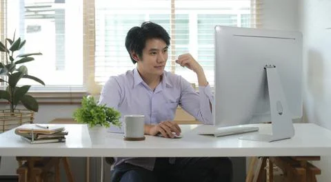 Handsome young businessman working with computer at home office. Stock-Fotos