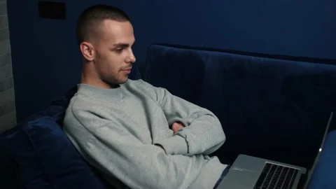 Handsome young caucasian man using laptop for watching movies. Stock Footage 144079019