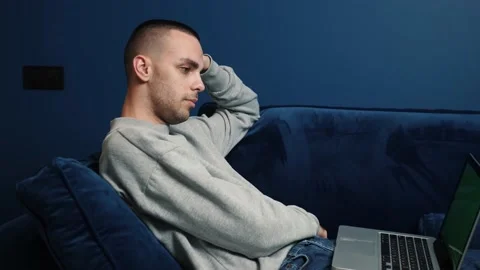 Handsome young caucasian man using laptop for watching movies. Green Screen Stock Footage 144079209