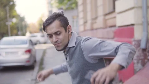 A handsome young cheerful guy is walking in the city. Running waving arms Stock-Footage 113973181