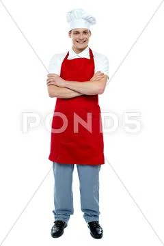 Handsome young cook posing in uniform Stock Photos