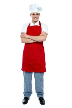 Handsome young cook posing in uniform Stock Photos