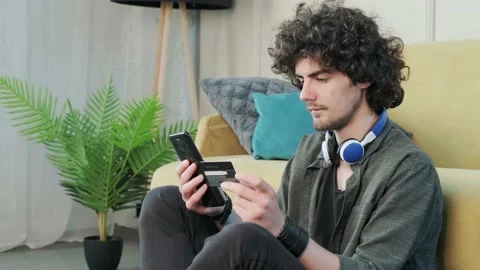 Handsome young curly haired guy looking at the camera with a happy facial Stock Footage 155236632