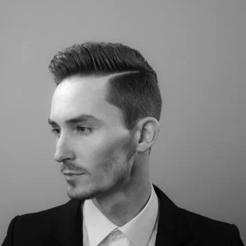 Handsome young elegant man studio portrait close-up. Stock Photos