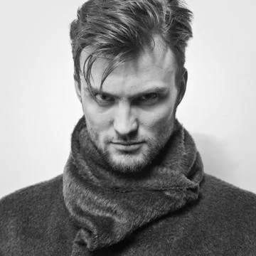 Handsome young elegant man studio portrait close-up. Stock Photos