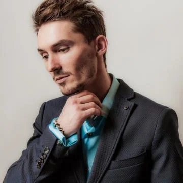 Handsome young elegant man studio portrait close-up. Stock Photos