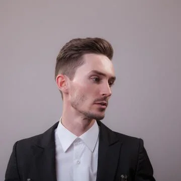 Handsome young elegant man studio portrait close-up. Stock Photos