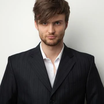 Handsome young elegant man studio portrait close-up. Stock Photos