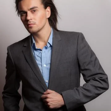 Handsome young elegant man studio portrait close-up. Stock Photos