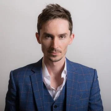 Handsome young elegant man studio portrait close-up. Stock Photos