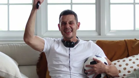 Handsome young excited while watching football. Stock Footage 163088294