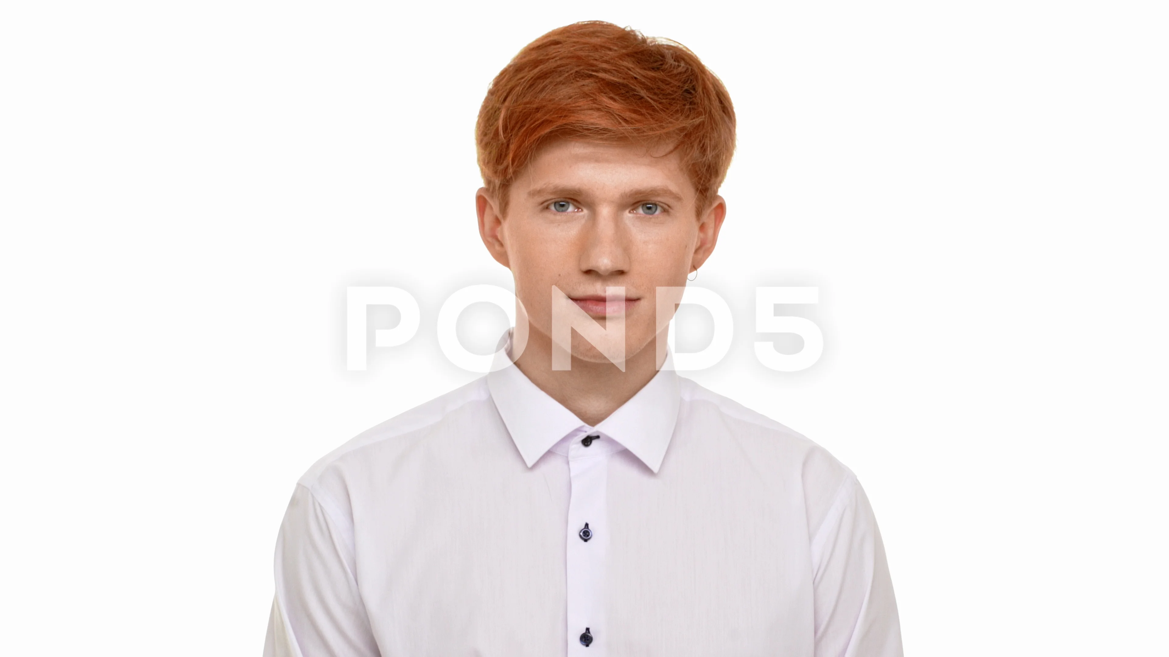 Handsome young ginger Caucasian man standing on white background and smiling