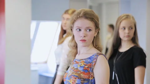 Handsome young girls take part in rehearsal in model school Stock Footage