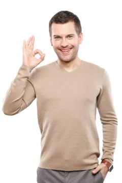 Handsome young guy is gesturing positively Stock Photos