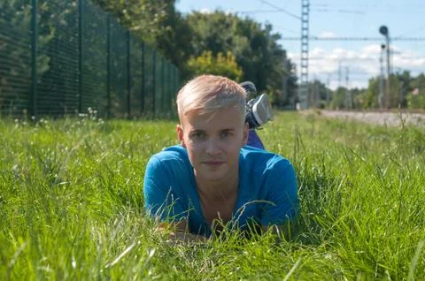 Handsome young guy on the grass Фото