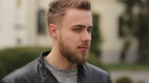 Handsome young guy looking on a camera Stock Footage 63469156