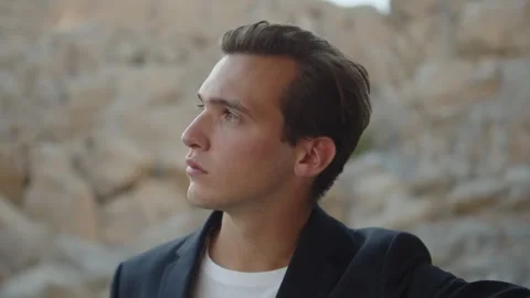 Handsome young guy model posing for camera in the mountains. Male fashion m.. Video stock 307161058