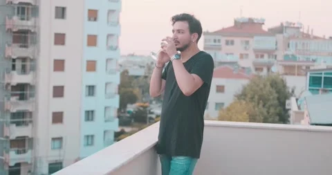 Handsome young guy is speaking with his mobile phone in a party time. Rest ti Video stock 156492095