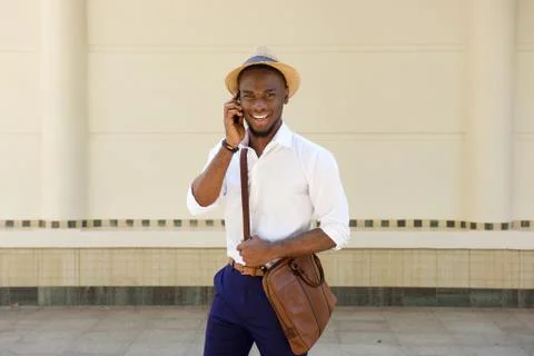 Handsome young guy talking on mobile phone Stock Photos