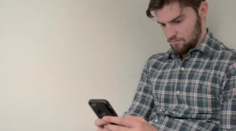 Handsome young guy using smart phone Stock Footage 55152637