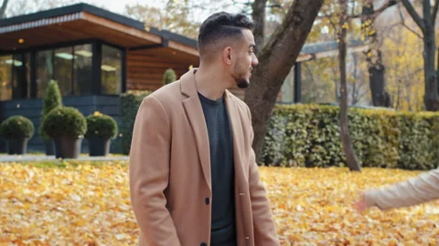 Handsome young guy wait looking at watch outdoors attractive woman coming on 스톡 동영상 165956039