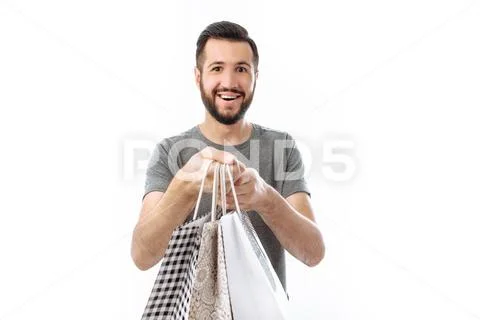Handsome young hipster, Shopaholic with bags. isolated on white background Stock Photos