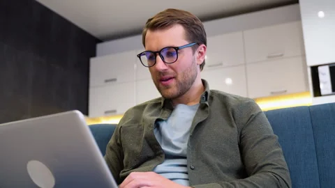 Handsome young male software developer programming codes while working from home Stock Footage 241955432