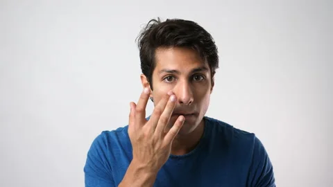 Handsome young man apply moisturizer or sunscreen on his beauty face  Stock Footage 137443182