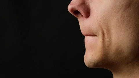 Handsome Young Man Applying Lip Balm Close Up Profile on Dark Background Male Stock Footage 317847840
