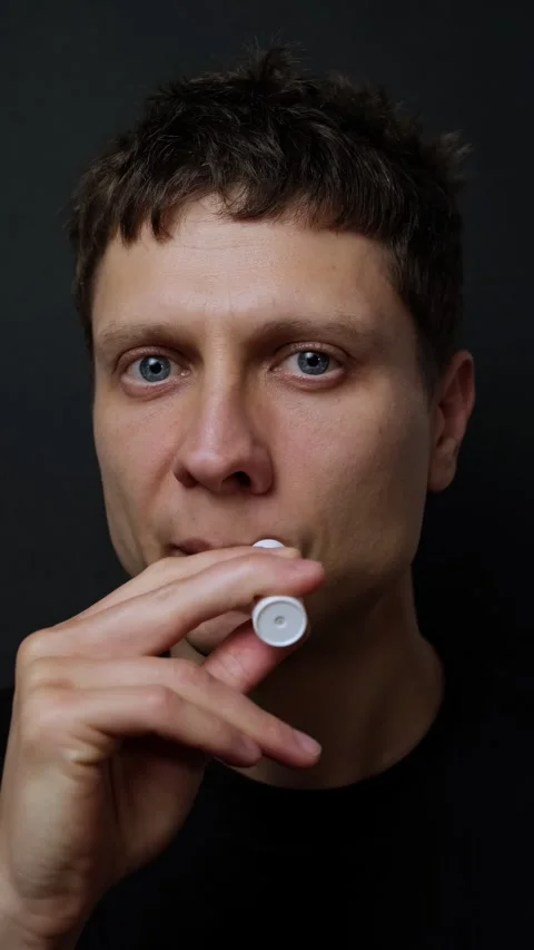 Handsome Young Man Applying Lip Balm Close Up Profile on Dark Background Male Stock Footage 318065474