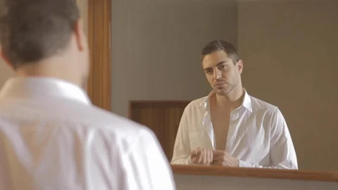 Handsome young man with a beard dressing with a white shirt and looking at 스톡 동영상 110914486