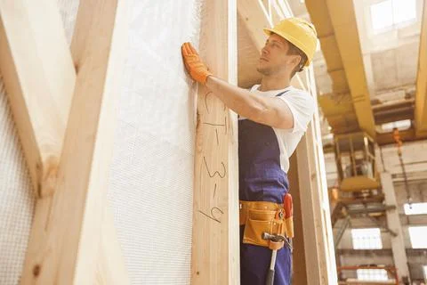 Handsome young man builder working at construction site Stock Photos