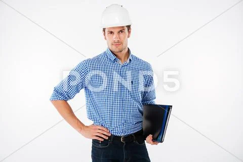 Handsome young man building engineer in helmet with folder Stock Photos