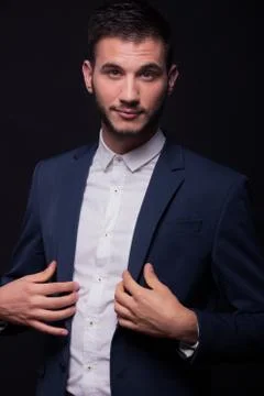 Handsome young man buttoning jacket suit Stock Photos