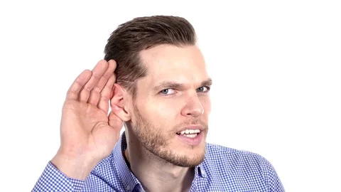 Handsome young man can't hear, putting hand around his ear Stock Footage 84010647