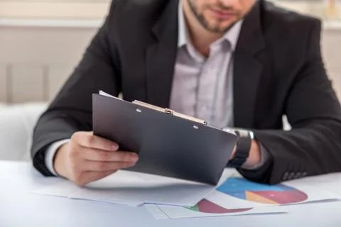Handsome young man is checking his sketches Stock Photos