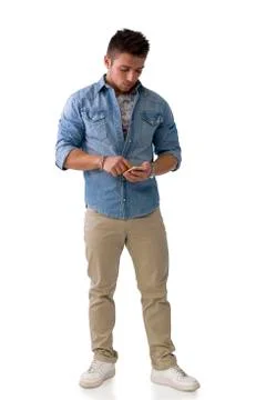 Handsome young man checking watch on his wrist Stock Photos