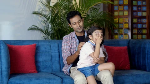 A handsome young man combing his son's hair while helping him in getting ready Stock Footage 165646028