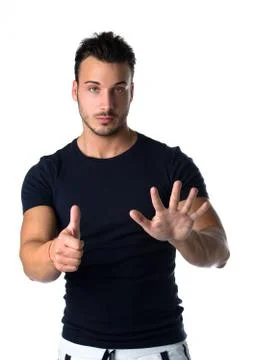 Handsome young man counting to six with fingers and hands Stock Photos