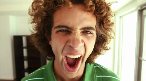 Handsome young man with curly hair yawns to camera, Close Up, Wide Angle lens Stock Footage