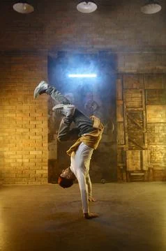 Handsome young man developing freeze over dance studio background Stockfoto's