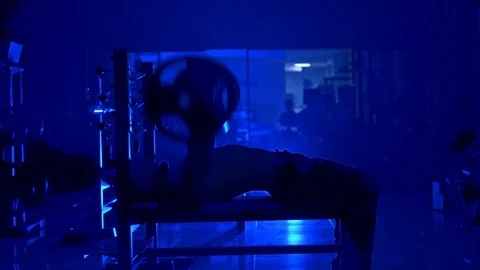 Handsome young man doing bench press workout in gym. Blue light filter. Stock-Footage 119152661