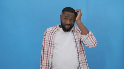 Handsome young man doing I do not know reaction, isolated on blue background. 4K Stock Footage 117505943