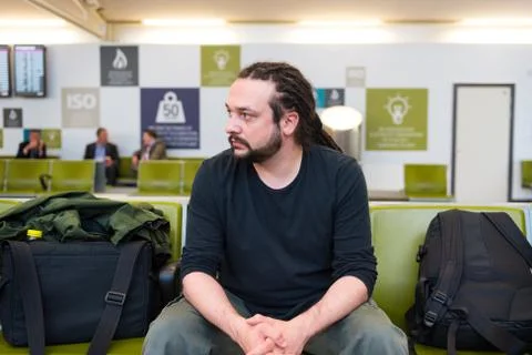 Handsome young man with dreadlocks waiting at an airport lounge. Stock-Fotos