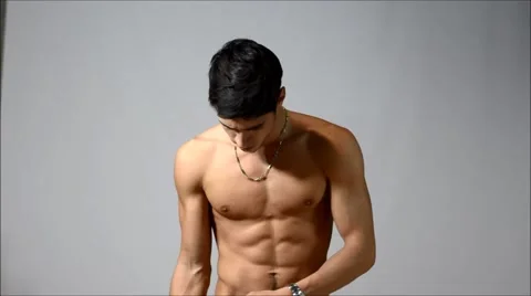 Handsome young man dressing, putting on t-shirt Stock Footage 46036959