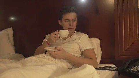 Handsome young man drinking coffee at home Stock Footage 73984286