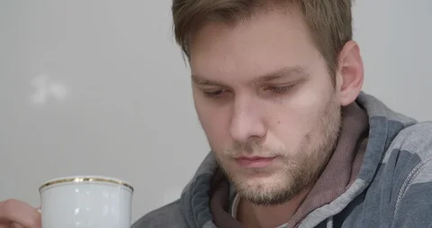Handsome young man drinking coffee in his home, close up shot. Stock Footage 124102580