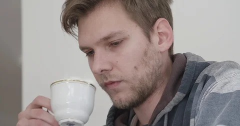 Handsome young man drinking coffee in his home, close up shot. Stock Footage 124104111